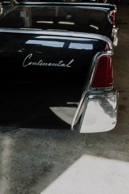 Vintage Continental car tail light inside a dimly lit garage.